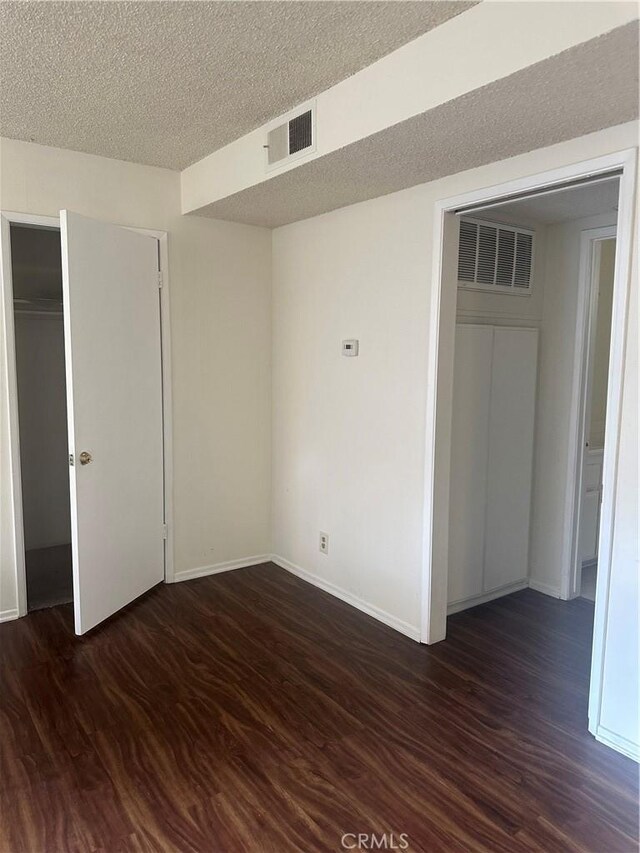 1524 Acacia St Unit 3, Alhambra, CA 91801 - unfurnished bedroom with dark wood-style floors, a closet, baseboards, and a textured ceiling