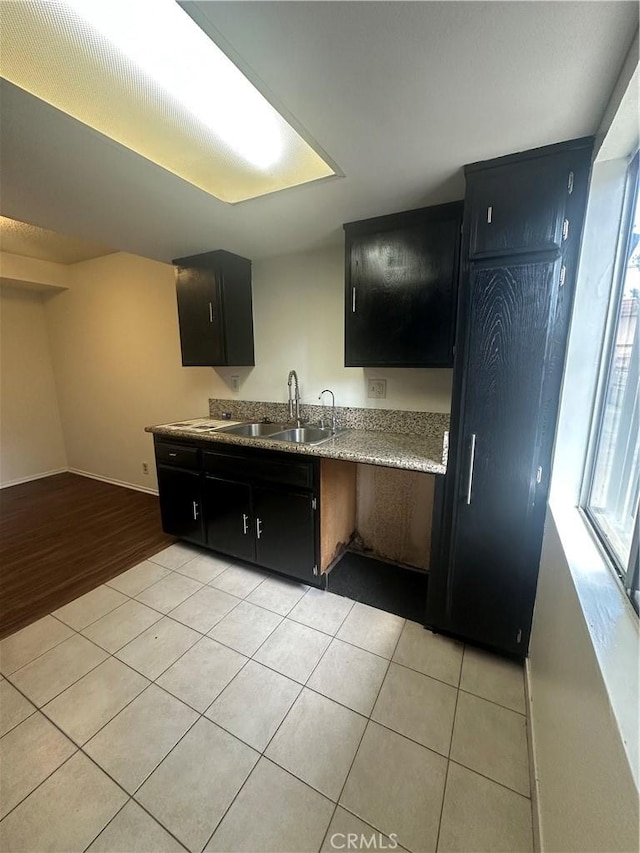 1524 Acacia St Unit 3, Alhambra, CA 91801 - kitchen with a sink, dark cabinetry, light tile patterned flooring, light countertops, and baseboards