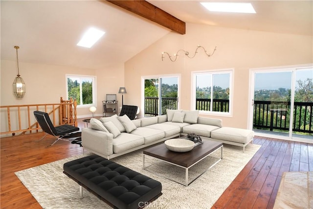 living area with beamed ceiling, high vaulted ceiling, and hardwood / wood-style floors