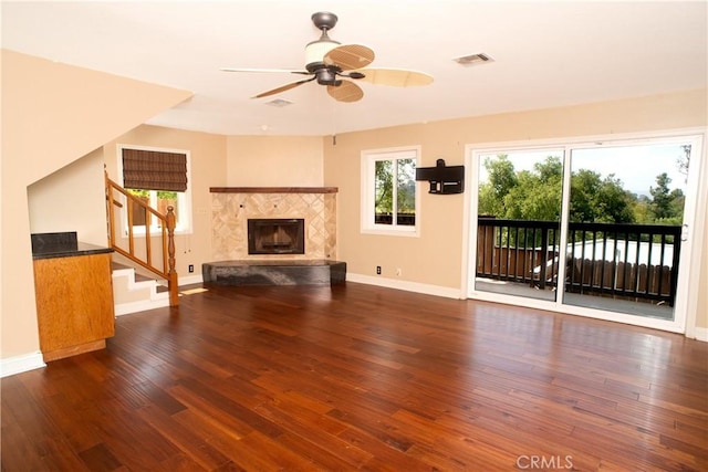 unfurnished living room with a ceiling fan, baseboards, visible vents, and wood finished floors