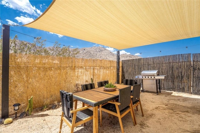 7073 Mission Ave Unit 29, Palms, CA 92277 - view of patio / terrace with a grill, outdoor dining area, and a mountain view