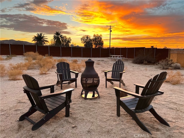 7073 Mission Ave Unit 29, Palms, CA 92277 - patio terrace at dusk featuring an outdoor fire pit