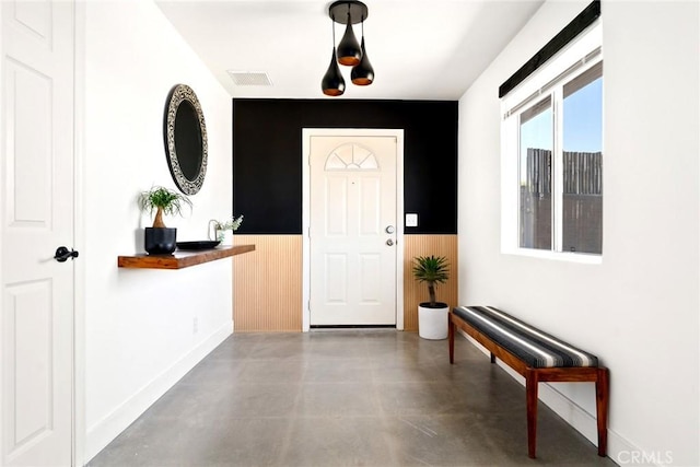 7073 Mission Ave Unit 29, Palms, CA 92277 - entryway with finished concrete floors, a wainscoted wall, and wooden walls