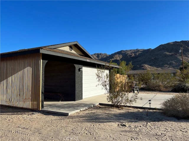 7073 Mission Ave Unit 29, Palms, CA 92277 - view of property exterior with a mountain view and a garage
