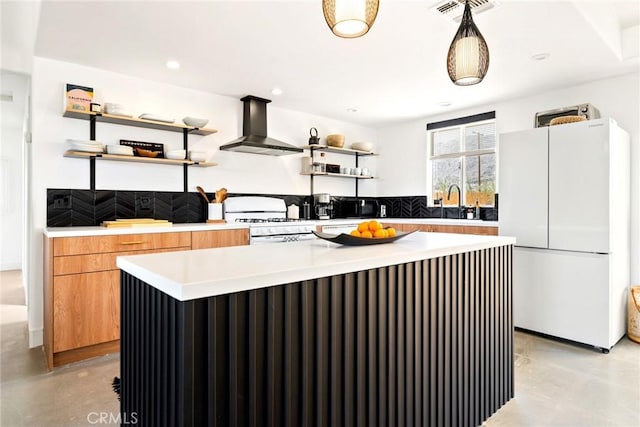 7073 Mission Ave Unit 29, Palms, CA 92277 - kitchen featuring wall chimney range hood, open shelves, white appliances, finished concrete flooring, and a center island