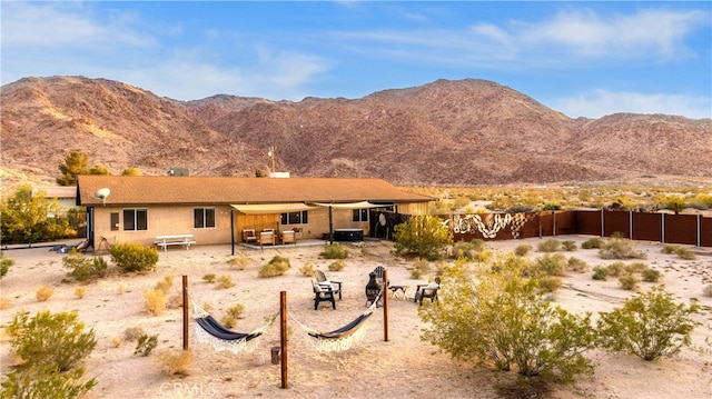 7073 Mission Ave Unit 29, Palms, CA 92277 - rear view of property featuring a mountain view, a patio, and stucco siding