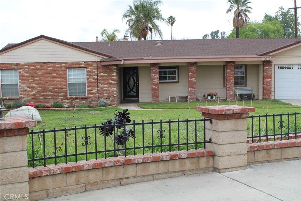 5966 Tucson Ct, Riverside, CA 92504 - single story home featuring brick siding, a fenced front yard, and a front lawn