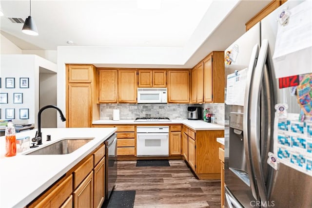 12325 Atoka Ln, Victorville, CA 92392 - kitchen featuring stainless steel appliances, a sink, light countertops, dark wood finished floors, and backsplash