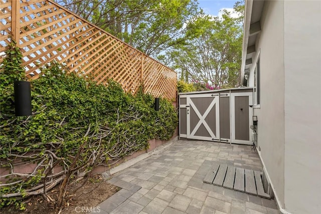 view of gate featuring a patio area