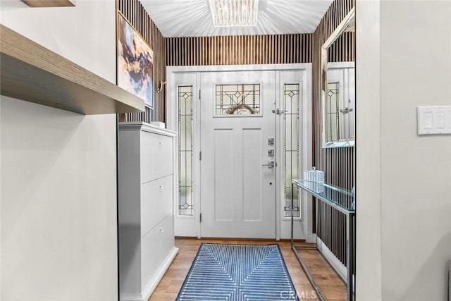 foyer entrance featuring a notable chandelier and light wood-style floors