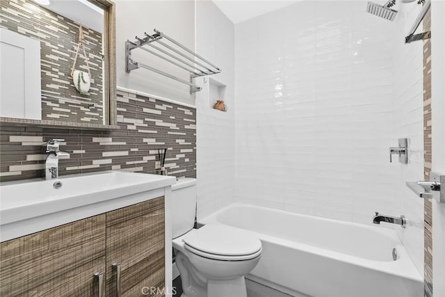 full bathroom featuring vanity, tile walls, toilet, bathtub / shower combination, and visible vents