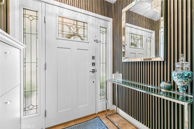 foyer entrance featuring wallpapered walls