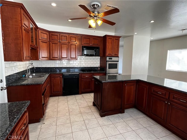 kitchen with a sink, decorative backsplash, black appliances, and a ceiling fan