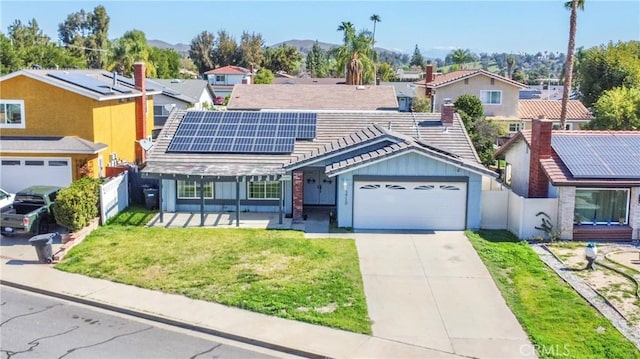 3710 Colonial Cir, Lake Elsinore, CA 92530 - view of front of house featuring a tiled roof, an attached garage, solar panels, fence, and a front lawn