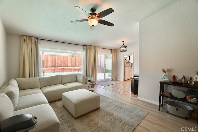 3710 Colonial Cir, Lake Elsinore, CA 92530 - living room featuring ceiling fan, baseboards, and light wood-type flooring