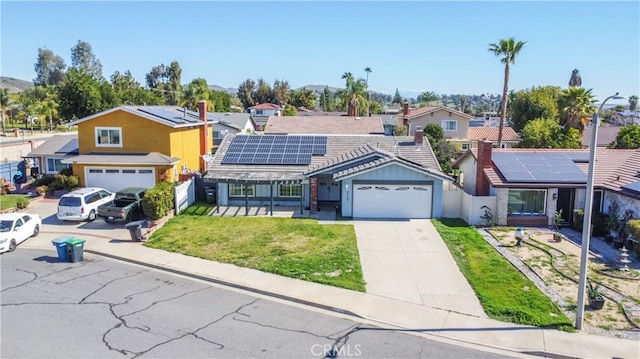 3710 Colonial Cir, Lake Elsinore, CA 92530 - ranch-style house featuring concrete driveway, solar panels, a front lawn, and fence