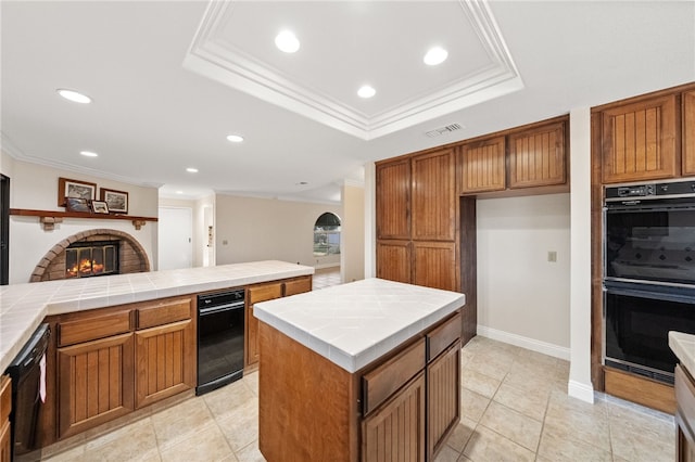 kitchen featuring crown molding, tile counters, black appliances, and visible vents