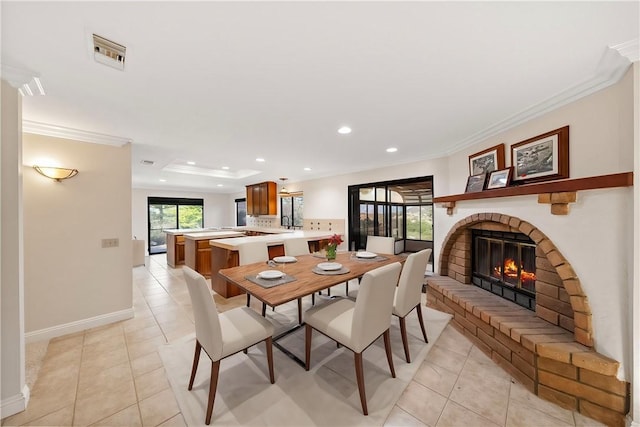 dining room featuring visible vents, crown molding, a fireplace, light tile patterned floors, and recessed lighting