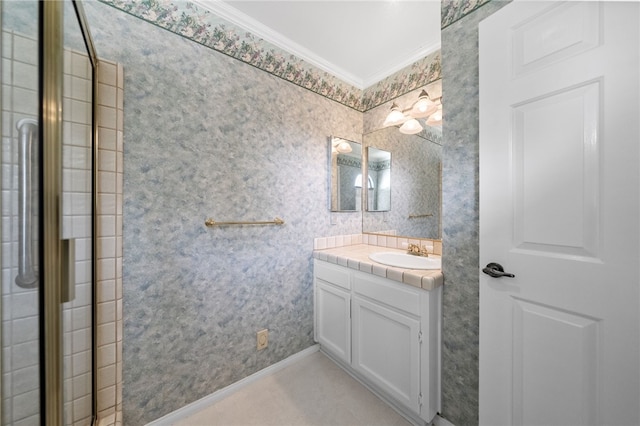 bathroom with crown molding, vanity, baseboards, and wallpapered walls