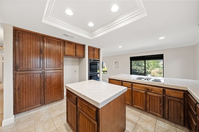 kitchen featuring tile counters, dobule oven black, white electric cooktop, recessed lighting, and visible vents