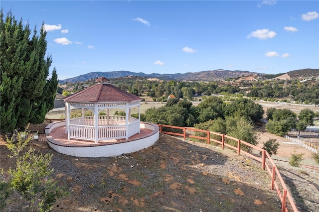 view of yard with a gazebo, fence, and a mountain view
