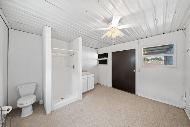 full bath featuring ceiling fan, carpet, a shower stall, and toilet