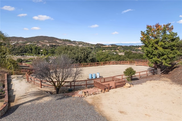view of yard with fence, a mountain view, and an enclosed area