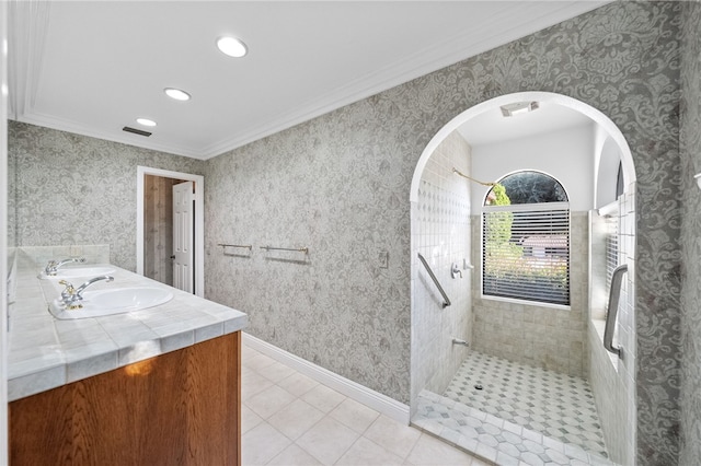 full bath with double vanity, visible vents, tile patterned flooring, a walk in shower, and ornamental molding