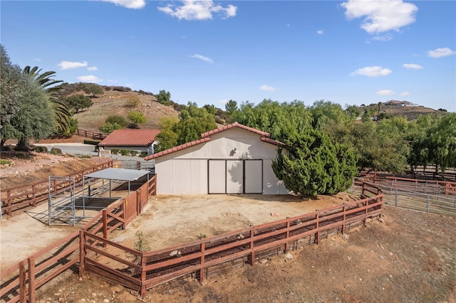 view of outbuilding with an outbuilding, an exterior structure, and a rural view