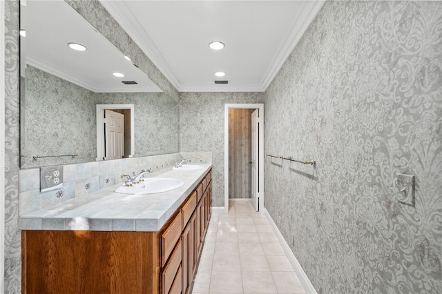 bathroom featuring double vanity, ornamental molding, a sink, and tile patterned flooring