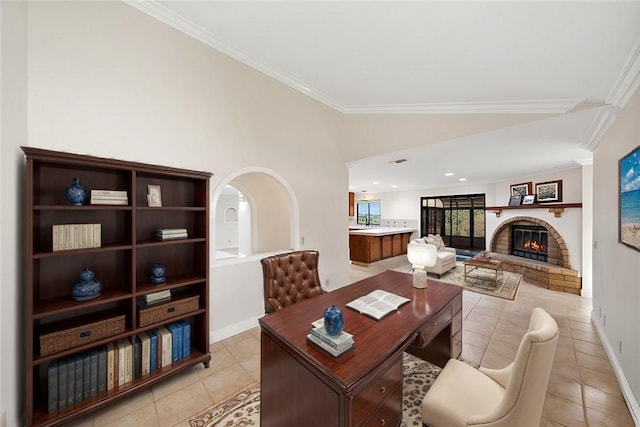 home office with crown molding, light tile patterned flooring, a fireplace, baseboards, and vaulted ceiling