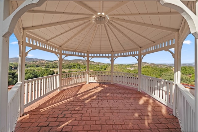 view of patio with a gazebo and a mountain view