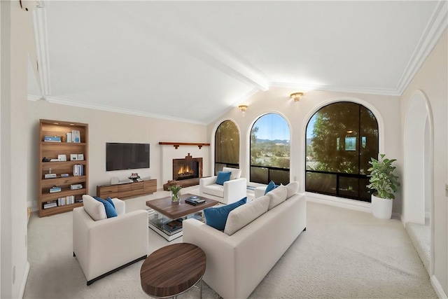 carpeted living room with crown molding, a warm lit fireplace, and lofted ceiling with beams