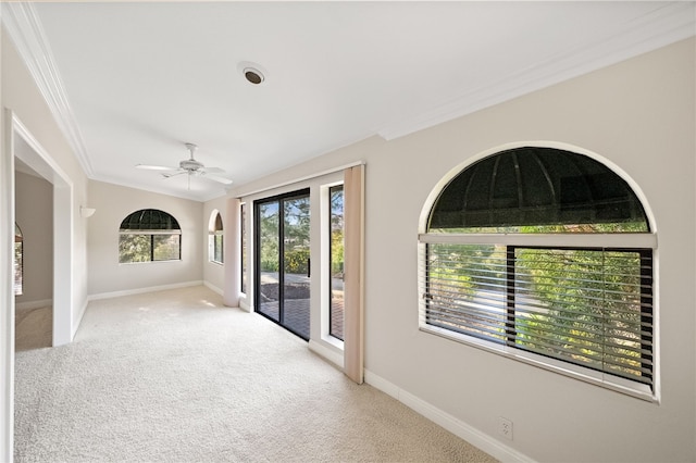 interior space with baseboards, ornamental molding, and a ceiling fan