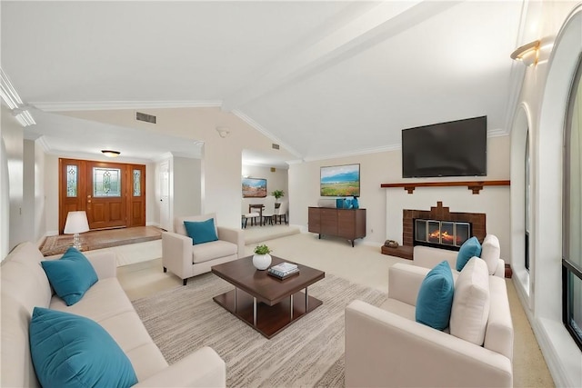 living area featuring visible vents, ornamental molding, lofted ceiling, and a fireplace