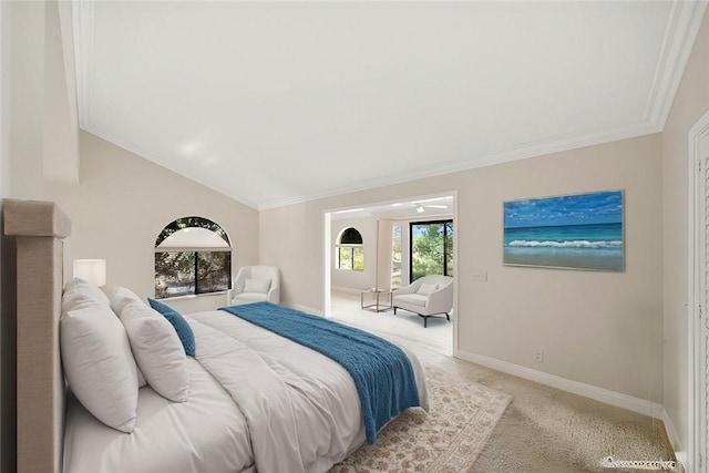 bedroom with crown molding, baseboards, light carpet, and lofted ceiling