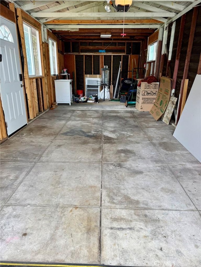 garage featuring a garage door opener and washer / dryer