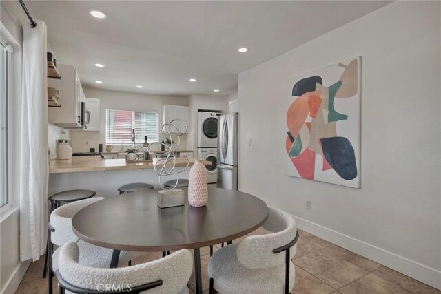 2019 Meade Ave, San Diego, CA 92116 - dining room with stacked washer / dryer, recessed lighting, baseboards, and light tile patterned floors