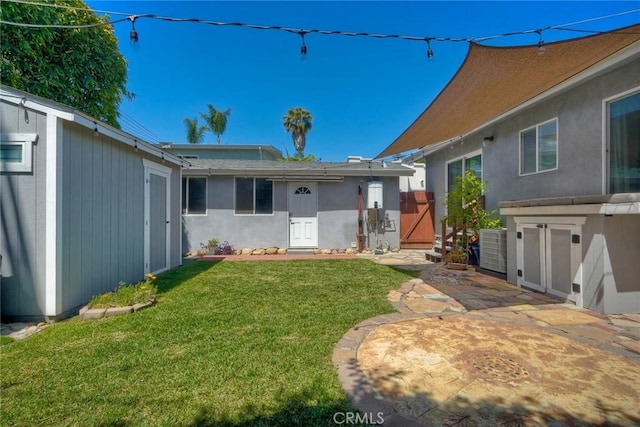 2019 Meade Ave, San Diego, CA 92116 - back of house featuring a lawn, a patio area, and an outdoor structure