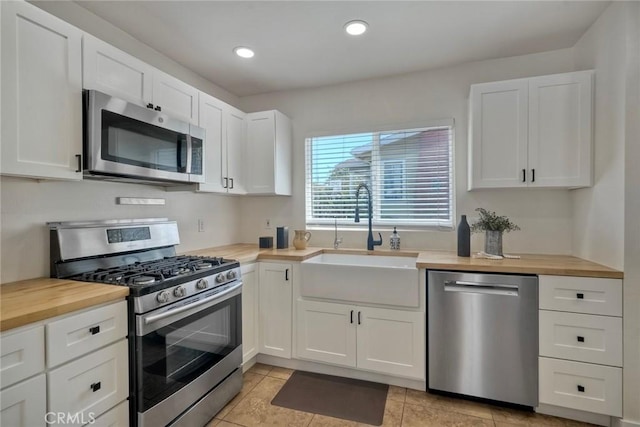 2019 Meade Ave, San Diego, CA 92116 - kitchen featuring stainless steel appliances, wooden counters, a sink, white cabinetry, and recessed lighting