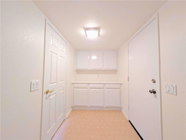 clothes washing area with light floors