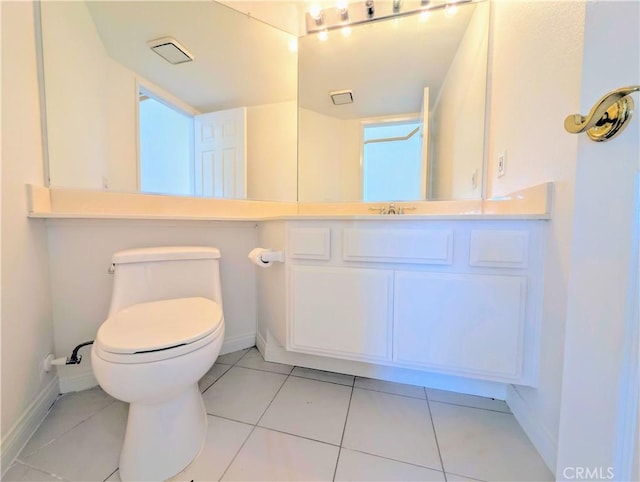 bathroom with baseboards, toilet, tile patterned flooring, and vanity