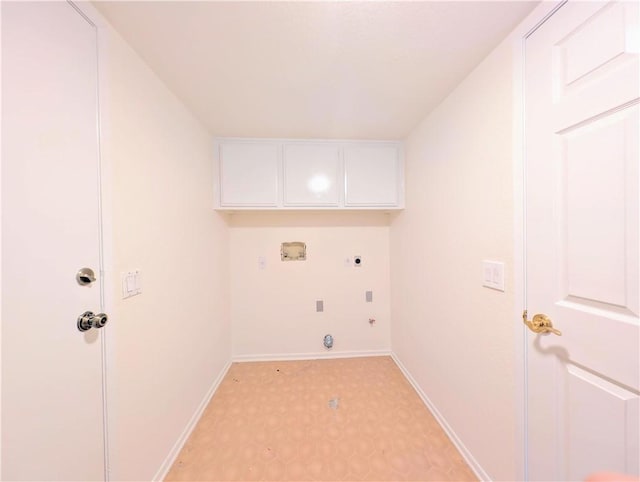 laundry area with hookup for an electric dryer, hookup for a gas dryer, baseboards, cabinet space, and light floors