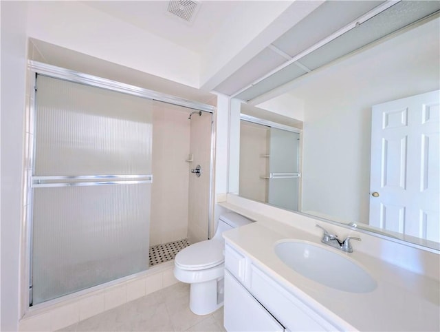 bathroom featuring visible vents, toilet, vanity, a stall shower, and tile patterned flooring