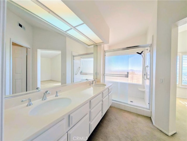 bathroom with lofted ceiling, a sink, a stall shower, and double vanity
