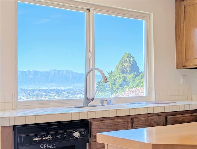 details with tile countertops and dishwasher