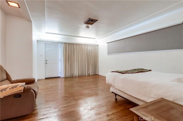 bedroom with baseboards and wood finished floors