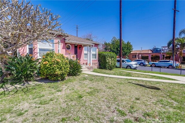 view of front of house with a front lawn and stucco siding