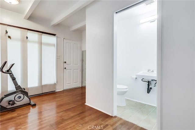 workout room with wood finished floors and baseboards