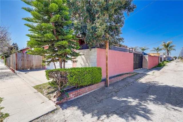 view of side of home featuring fence